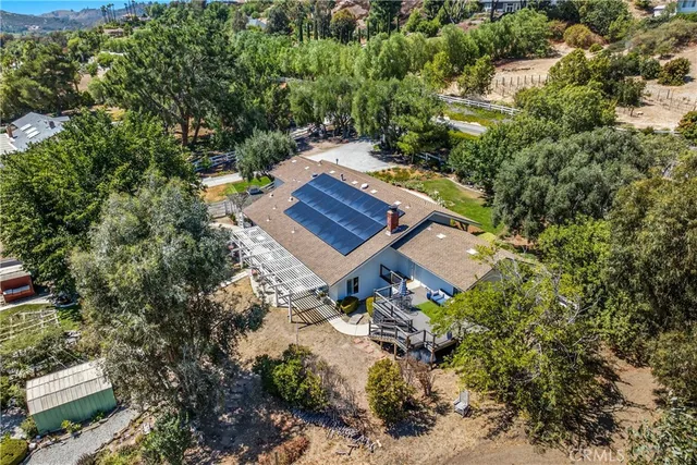 a view of a house with a backyard and garden