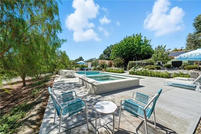 a view of a patio with couches table and chairs and potted plants