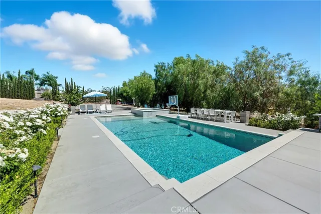 a view of a roof deck with couches chairs and wooden floor