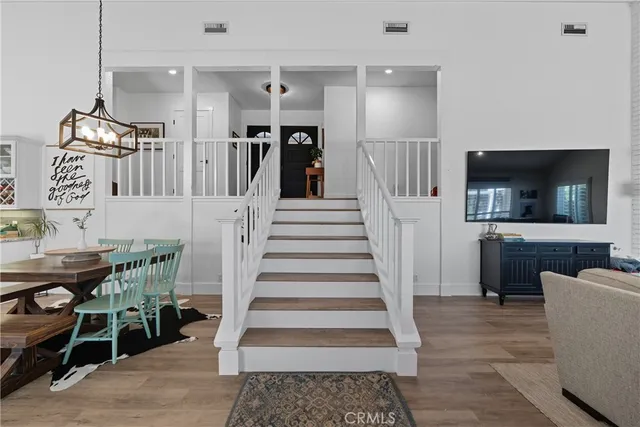 a large kitchen with cabinets wooden floor and stainless steel appliances