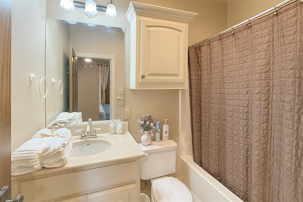 1026 Farm To Market Road 131 Denison, TX 75020 - Photo 22 of 40 a bathroom with a sink a toilet and shower curtain