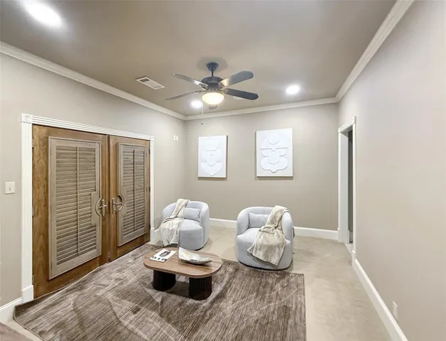a living room with furniture and a ceiling fan