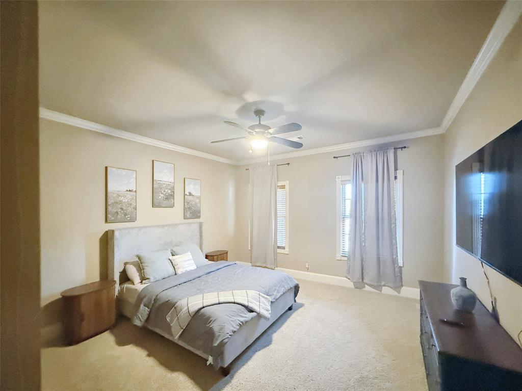 1026 Farm To Market Road 131 Denison, TX 75020 - Photo 33 of 40 a bedroom with a large bed and a flat tv screen on a dresser
