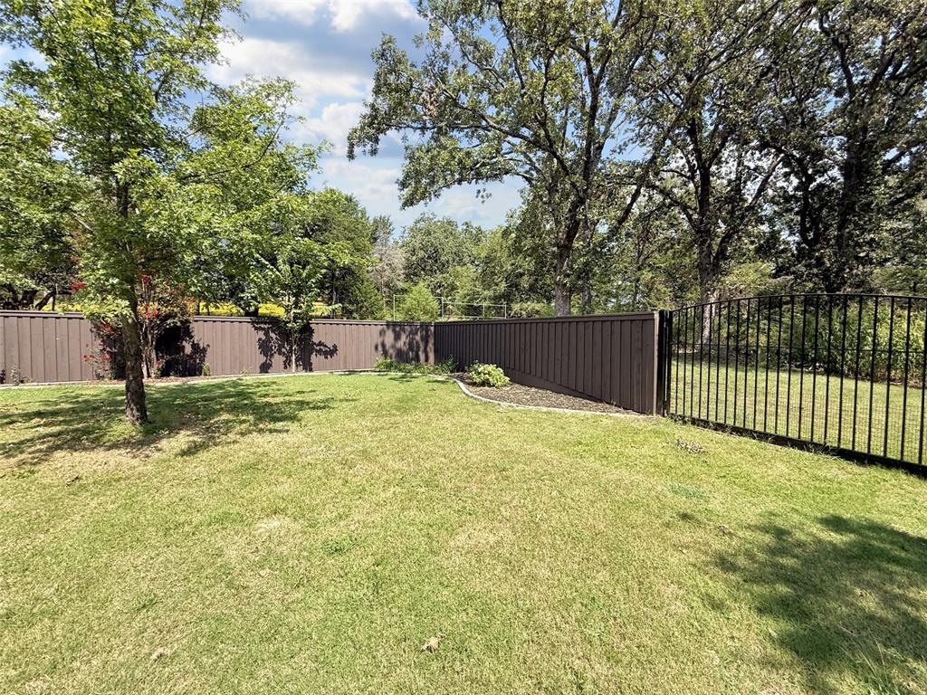 1026 Farm To Market Road 131 Denison, TX 75020 - Photo 38 of 40 a view of a backyard with a large tree