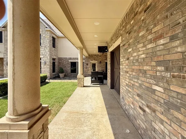 a view of a porch with furniture and a yard