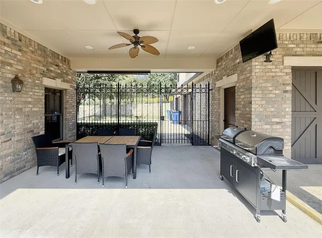 a living room with furniture a flat screen tv and a large window