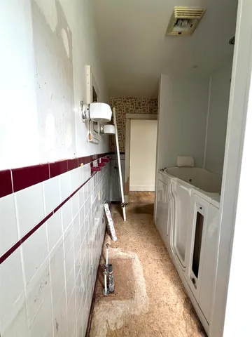 a view of an house with backyard space and balcony