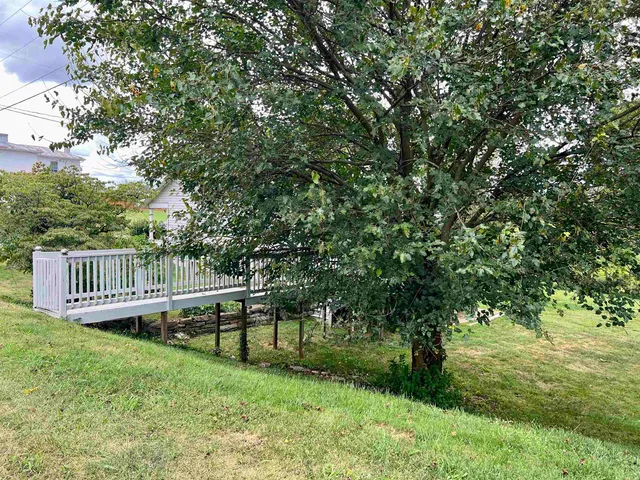a view of a chair and table in the garden
