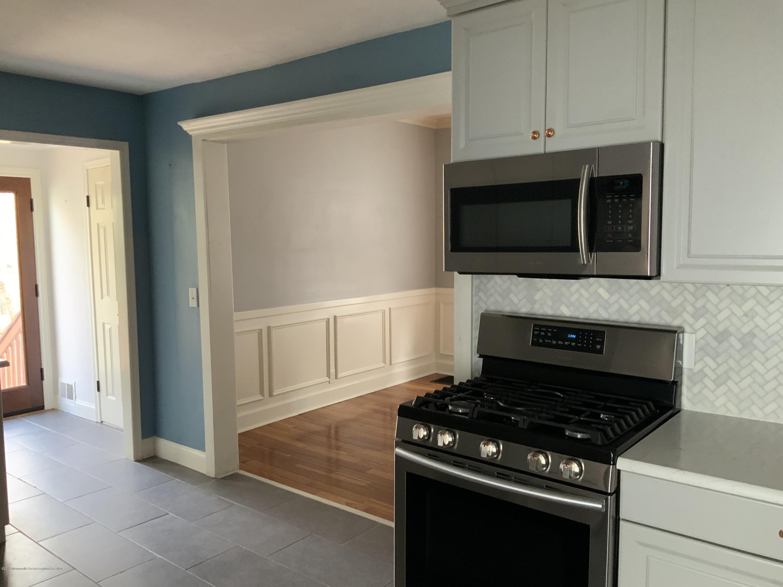 15 Spring Street Red Bank, NJ 07701 - Photo 11 of 30 a kitchen with stainless steel appliances a stove and a microwave