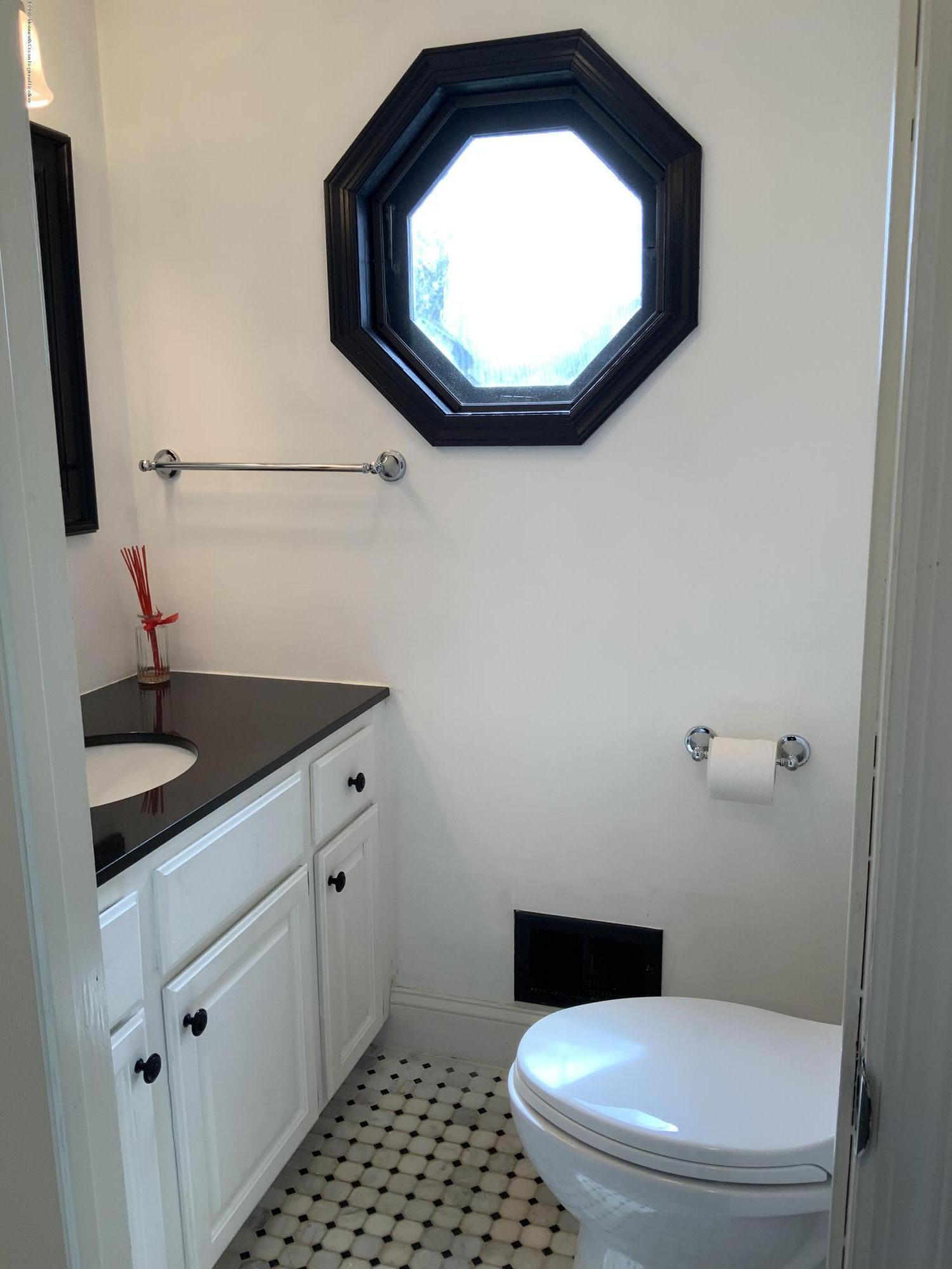 15 Spring Street Red Bank, NJ 07701 - Photo 12 of 30 a bathroom with a toilet and a sink