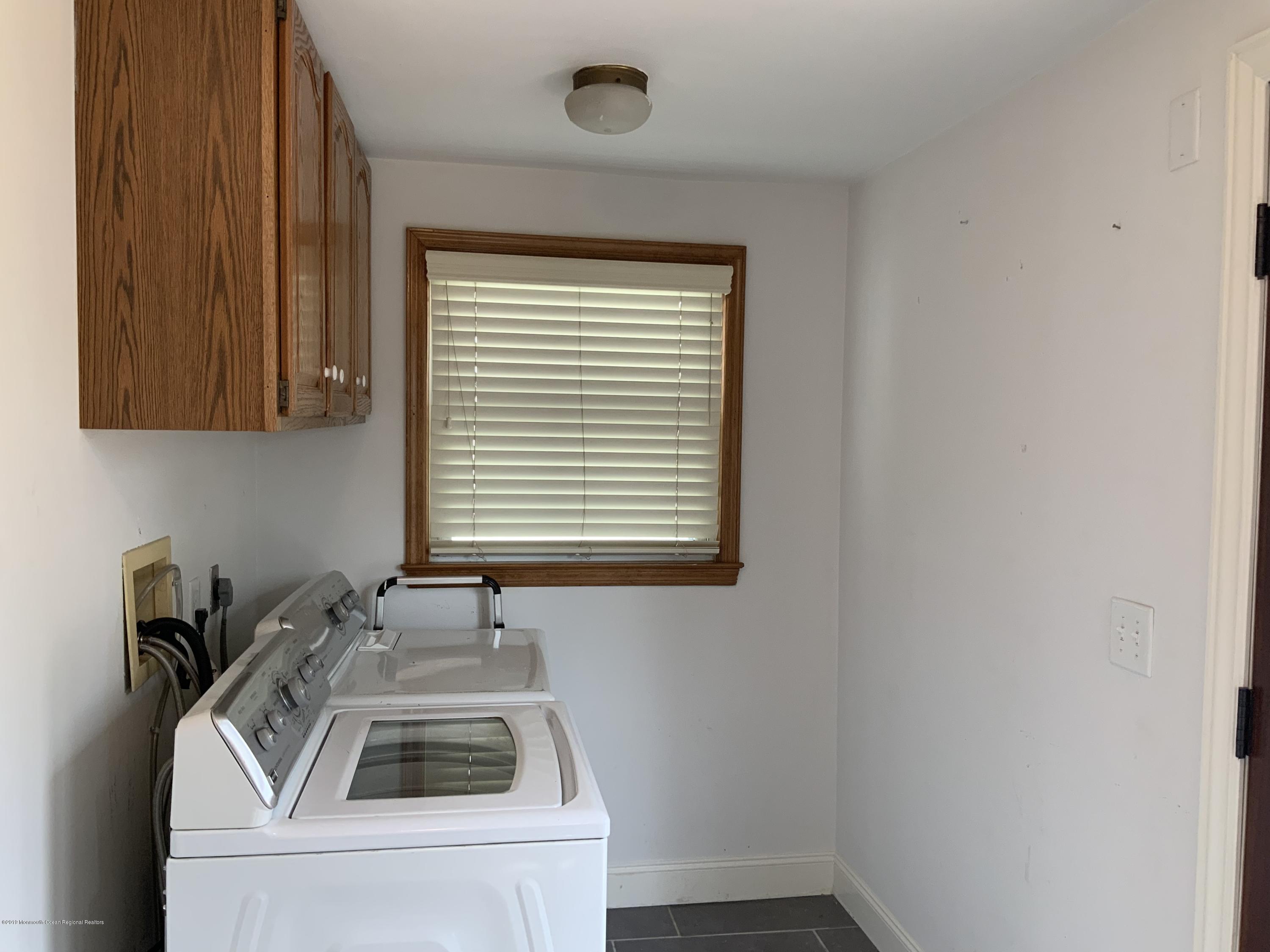 15 Spring Street Red Bank, NJ 07701 - Photo 15 of 30 a kitchen with a sink and cabinets