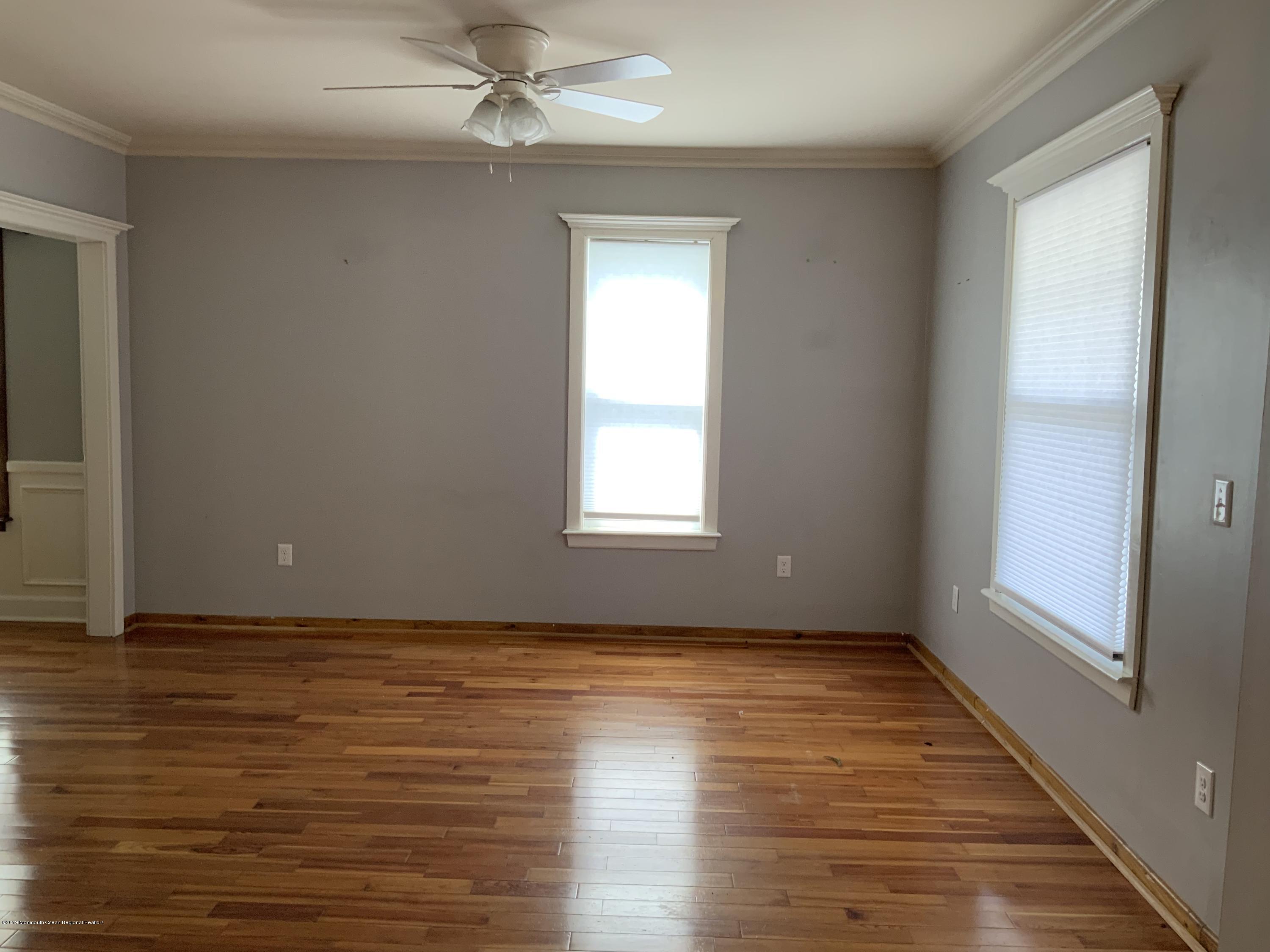 15 Spring Street Red Bank, NJ 07701 - Photo 4 of 30 a view of an empty room with wooden floor and a window