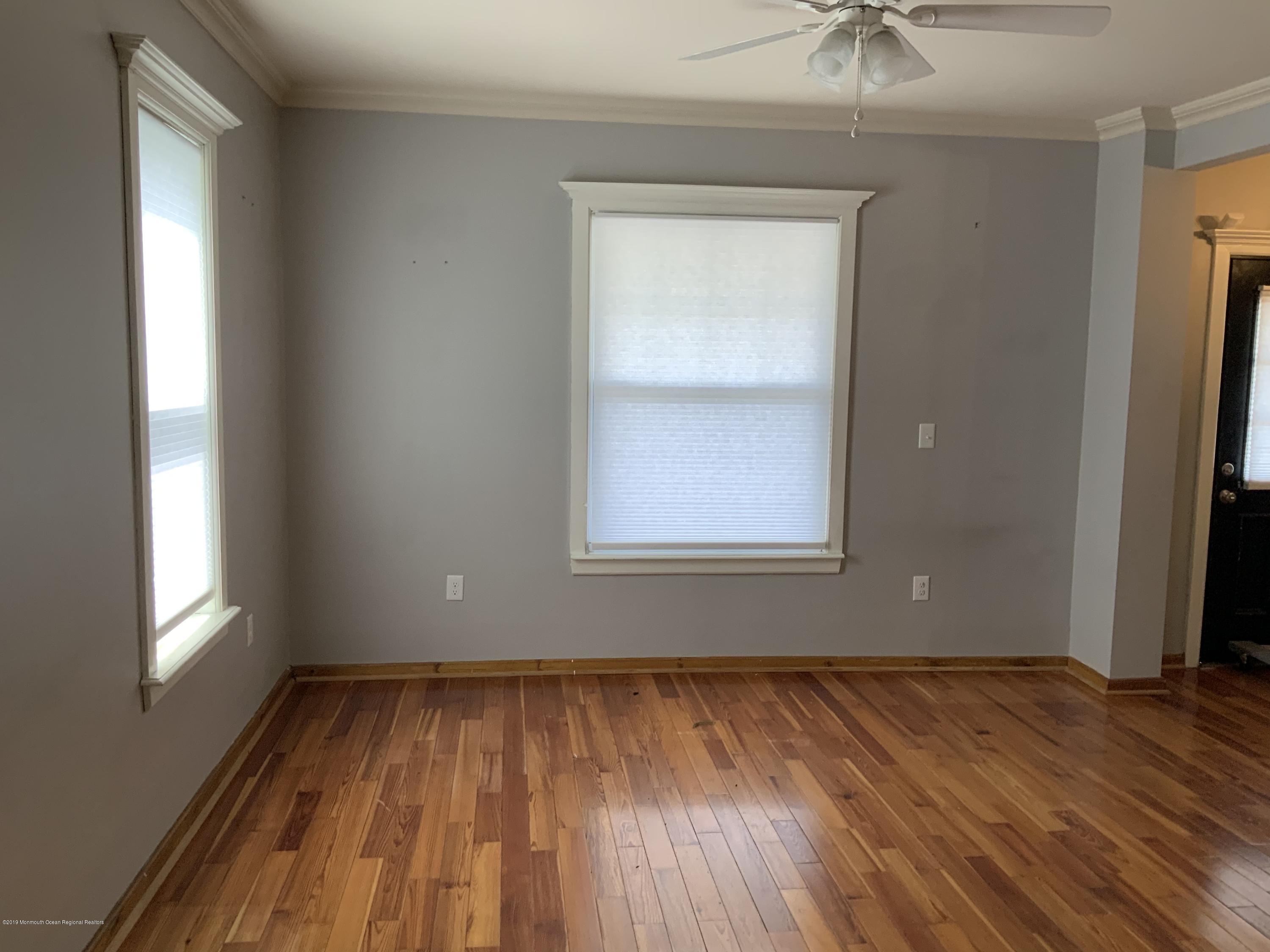 15 Spring Street Red Bank, NJ 07701 - Photo 5 of 30 an empty room with a window and wooden floor