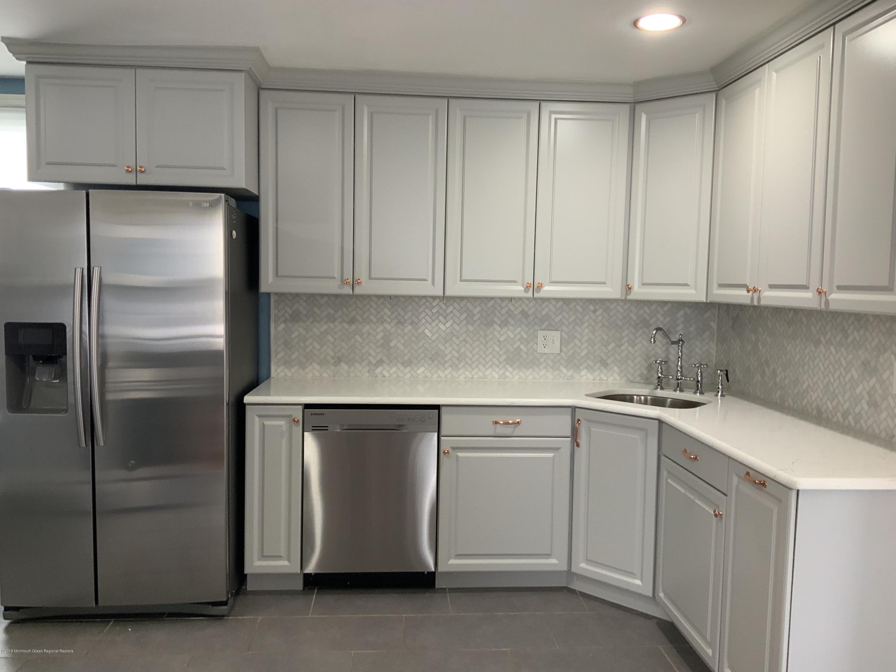 15 Spring Street Red Bank, NJ 07701 - Photo 7 of 30 a kitchen with cabinets and stainless steel appliances