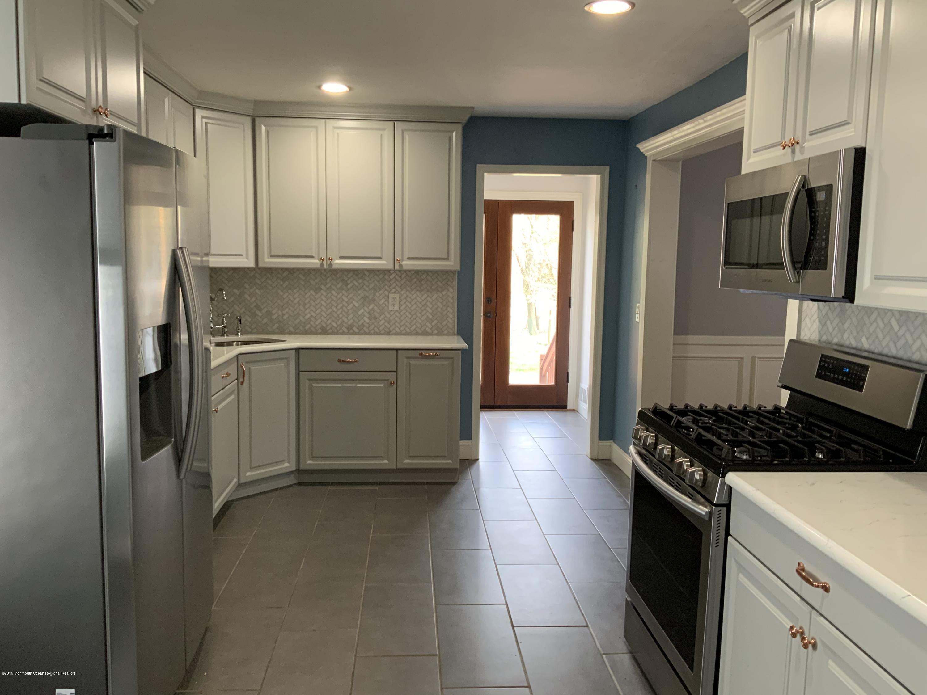15 Spring Street Red Bank, NJ 07701 - Photo 8 of 30 a kitchen with stainless steel appliances granite countertop a sink stove and refrigerator