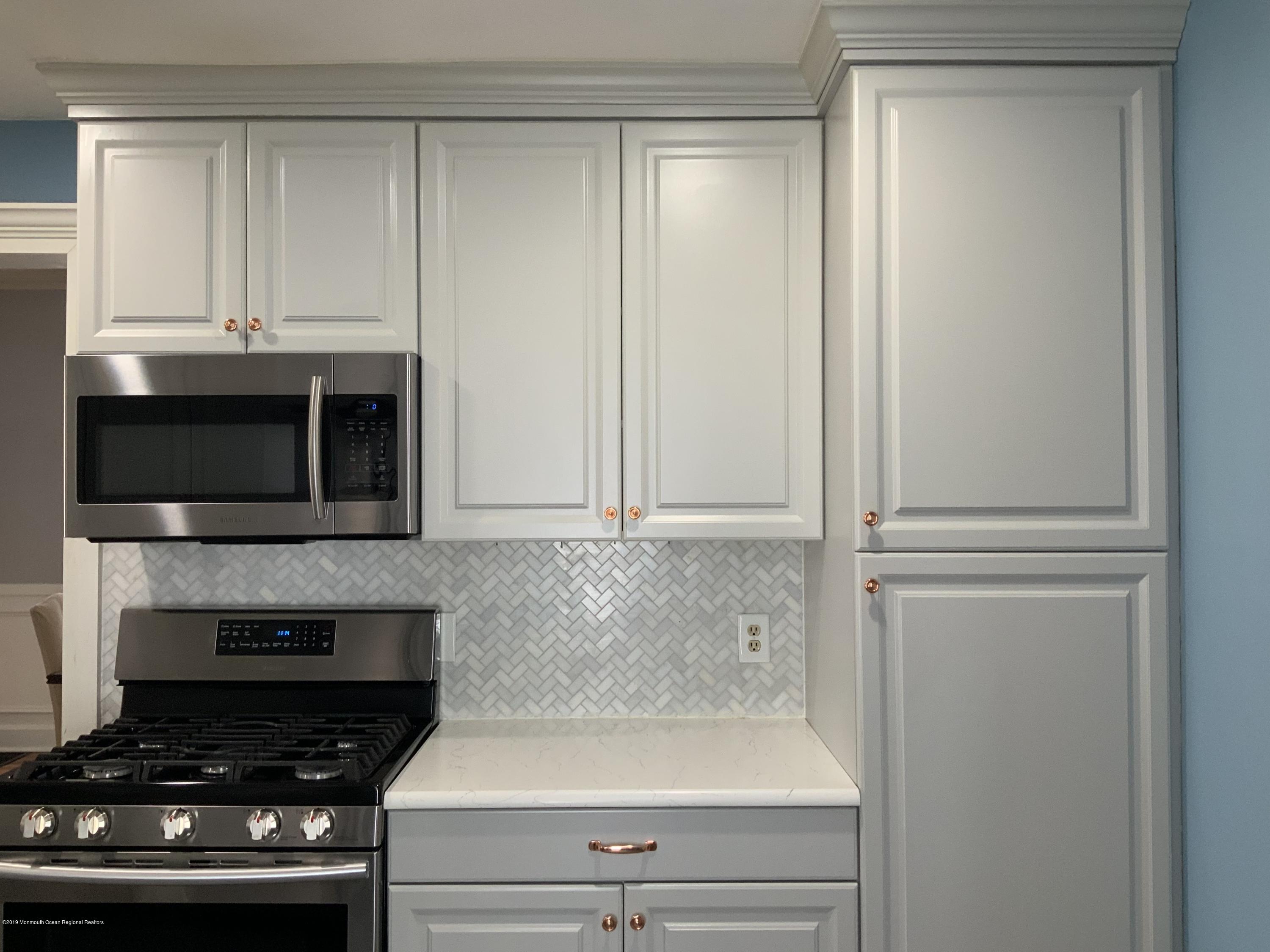 15 Spring Street Red Bank, NJ 07701 - Photo 10 of 30 a kitchen with a stove and a microwave