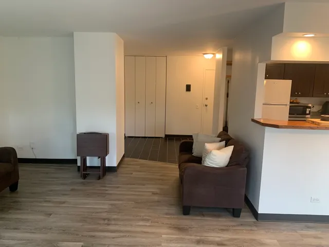 a living room with furniture and a lamp