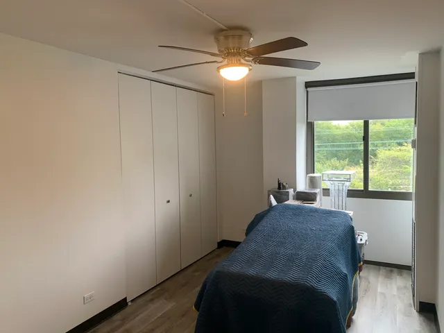 a spacious bedroom with a bed and a window