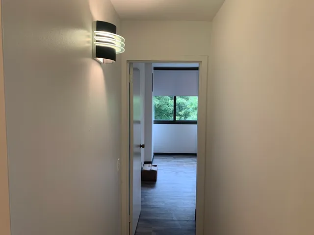 a view of a room with wooden floor closet and windows