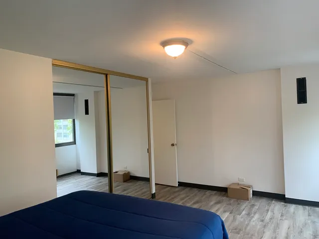 a view of an empty room and wooden floor