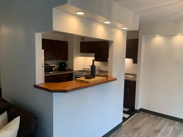 a kitchen with stainless steel appliances granite countertop a sink and a stove