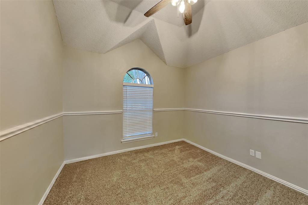 1526 Brittany Lane Mansfield, TX 76063 - Photo 11 of 18 Empty room featuring light carpet, a textured ceiling, lofted ceiling, and ceiling fan