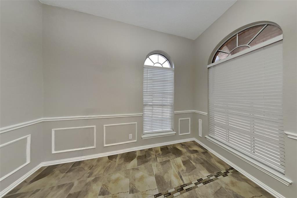 1526 Brittany Lane Mansfield, TX 76063 - Photo 5 of 18 Unfurnished room with a decorative wall and a wainscoted wall
