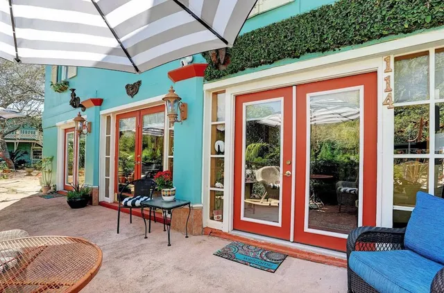 a outdoor living space with furniture potted plant and a large window