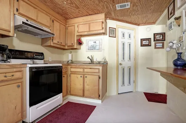a kitchen with stainless steel appliances granite countertop a stove and a refrigerator
