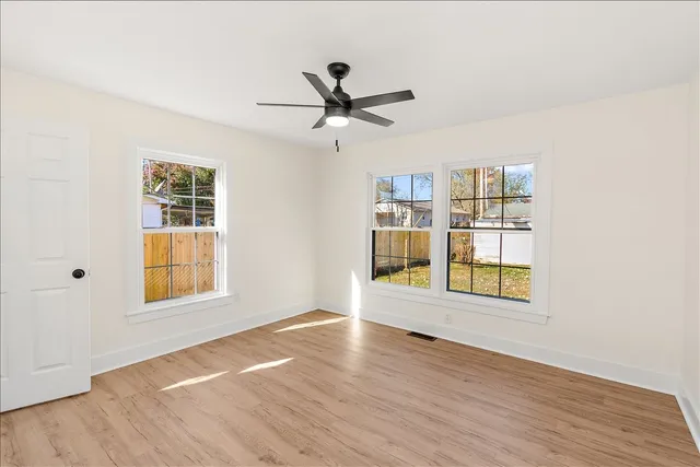 wooden floor in an empty room with a window