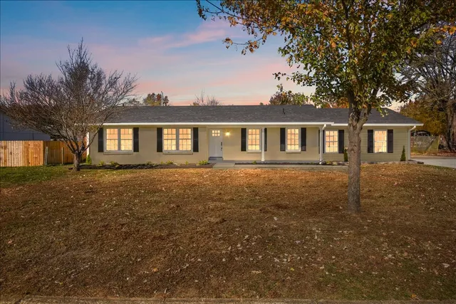 a front view of a house with yard and green space
