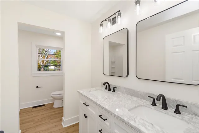 a bathroom with 2 sink and a mirror