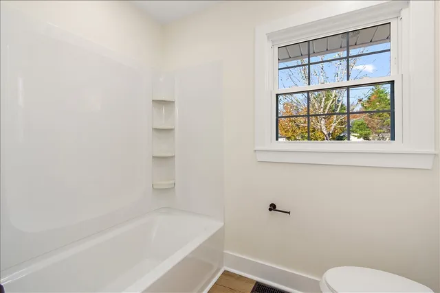 a bathroom with a toilet and a bathtub