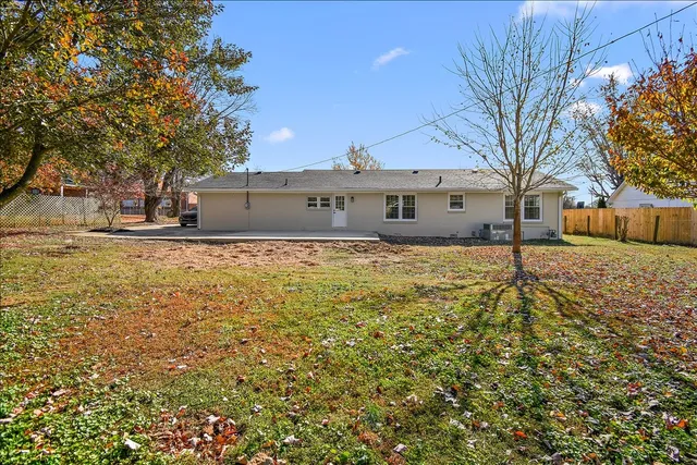 a view of a house with a large tree