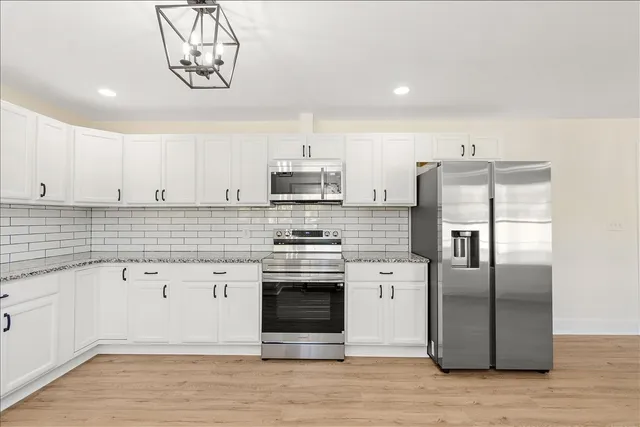 a kitchen with a refrigerator and a sink