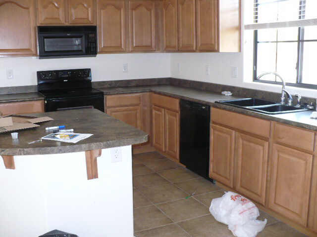 2333 West Sleepy Ranch Road Phoenix, AZ 85085 - Photo 6 of 6 a kitchen with stainless steel appliances granite countertop a sink stove and microwave