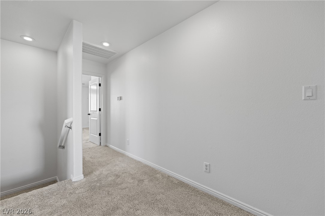 575 Gann Avenue Logandale, NV 89021 - Photo 39 of 75 A well-lit landing area connects private spaces, offering comfortable transitions.