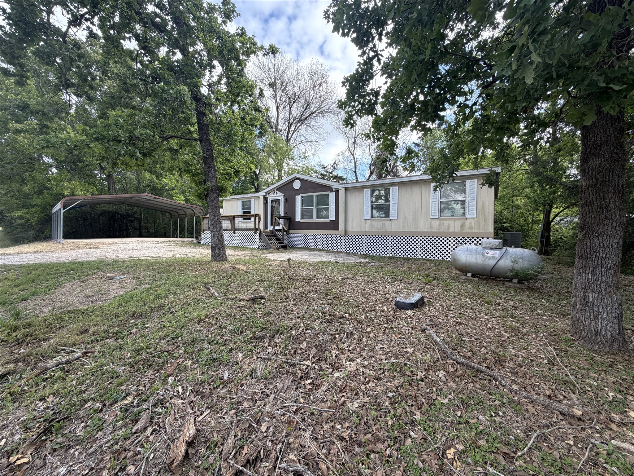 161 Farm To Market 1617 Trinity, TX 75862 - Photo 1 of 15 a house that has a tree in front of the house