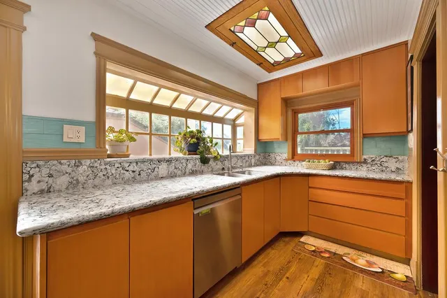 a kitchen with stainless steel appliances granite countertop a stove and cabinets