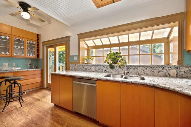 a view of a workspace with furniture and a window