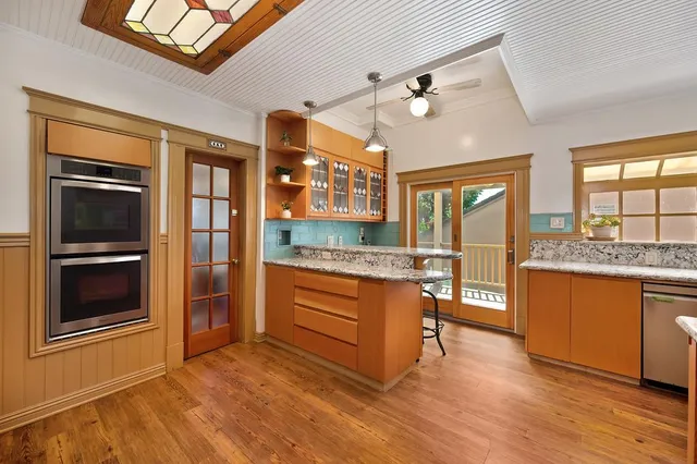a bedroom with a large bed and wooden floor