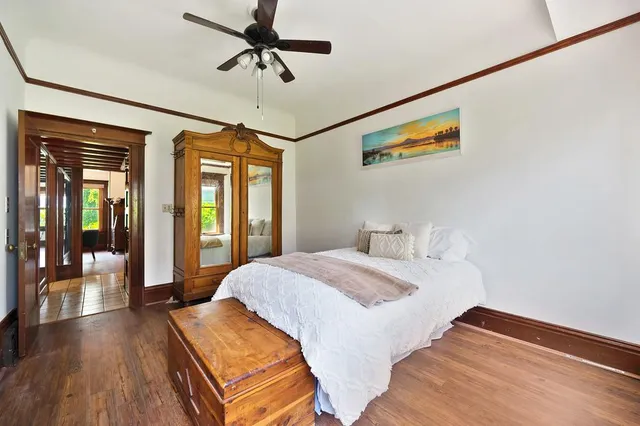 a bathroom with a sink a mirror a toilet and a window