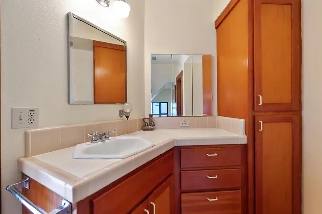 a view of balcony with wooden floor and seating space