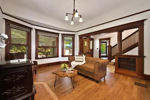 a bedroom with furniture and wooden floor