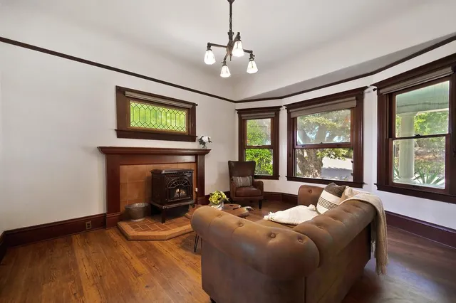 a dining room with furniture a chandelier and wooden floor