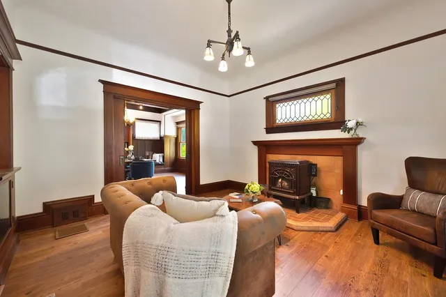 a living room with furniture a rug and wall painting