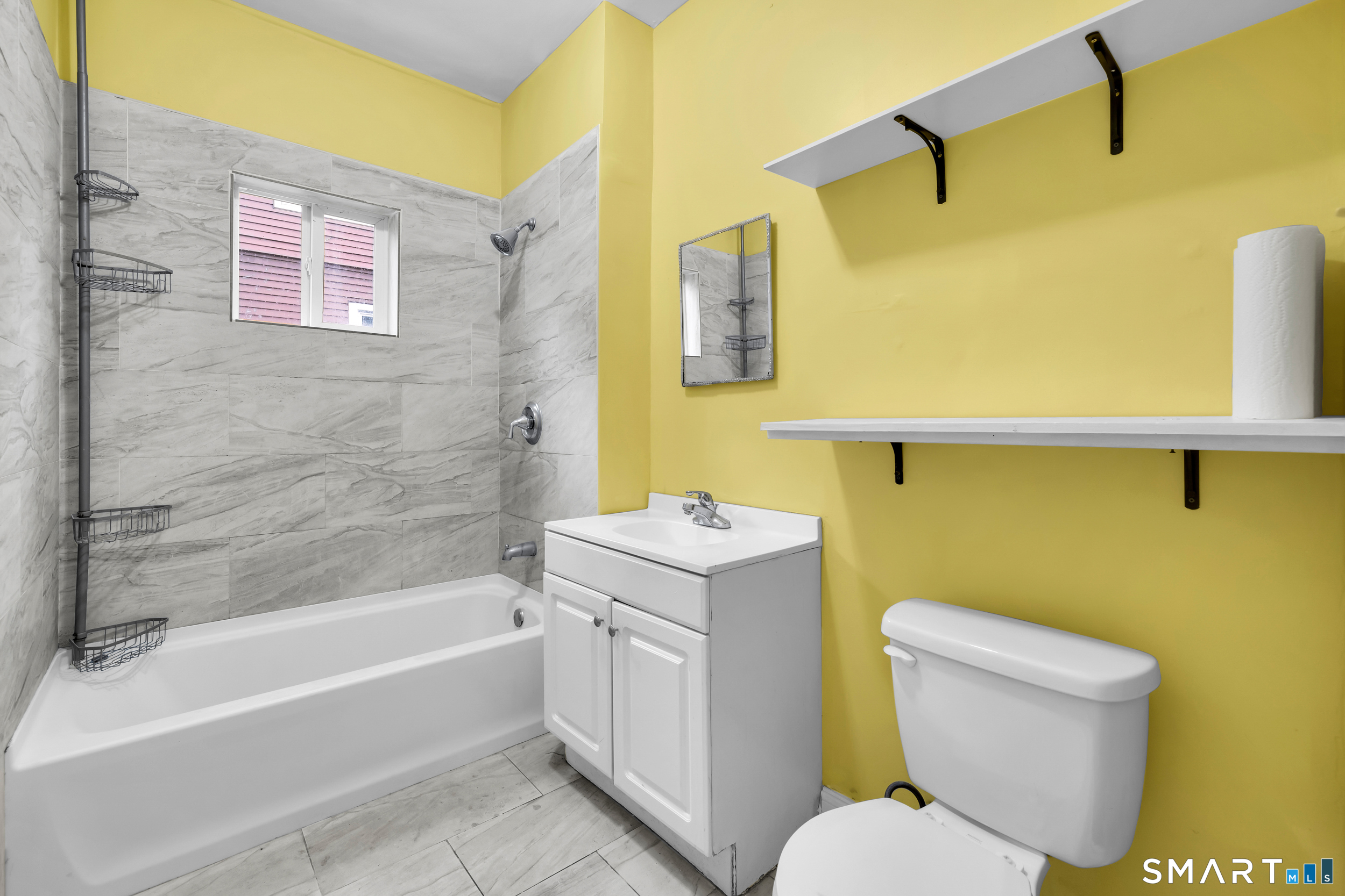 72 Sterling Street Hartford, CT 06112 - Photo 16 of 25 a bathroom with a sink a toilet and bathtub