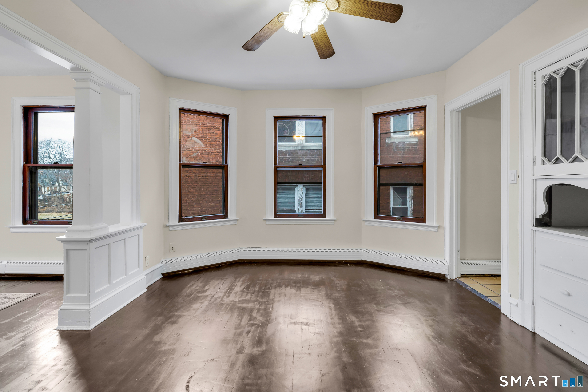 72 Sterling Street Hartford, CT 06112 - Photo 6 of 25 a view of an empty room with wooden floor and a window