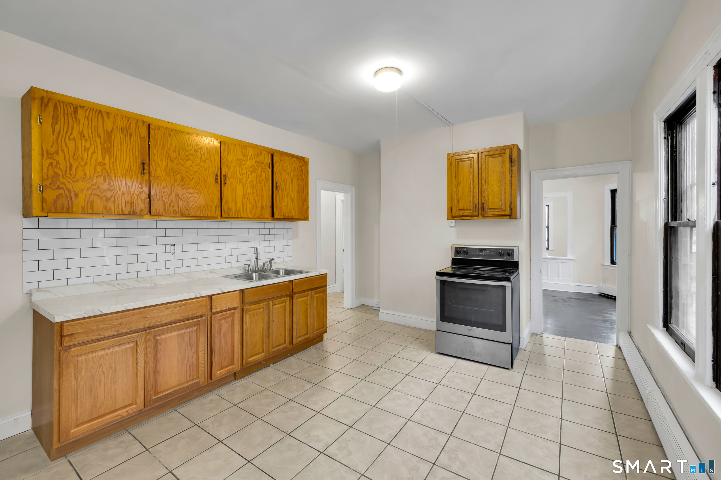 72 Sterling Street Hartford, CT 06112 - Photo 9 of 25 a kitchen with stainless steel appliances a stove a sink and a refrigerator