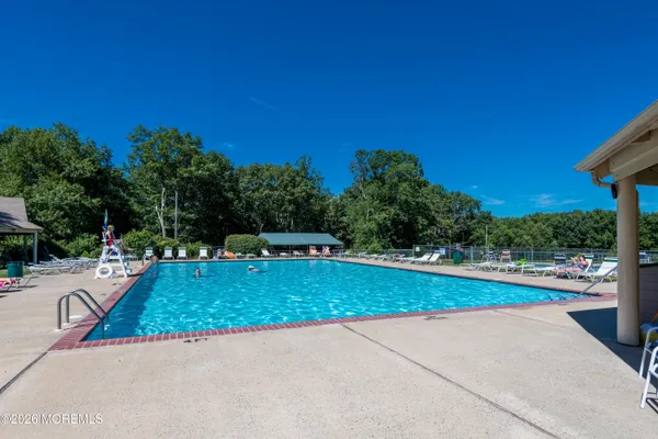 a view of a swimming pool with a yard